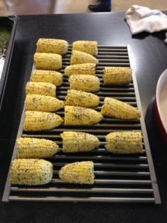 Corn Being Fried on a Metallic Grill