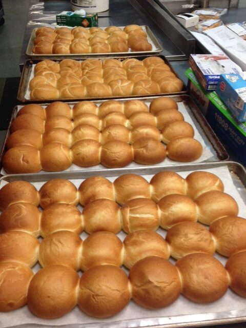 Trays Filled With Baked Buns on Parchment